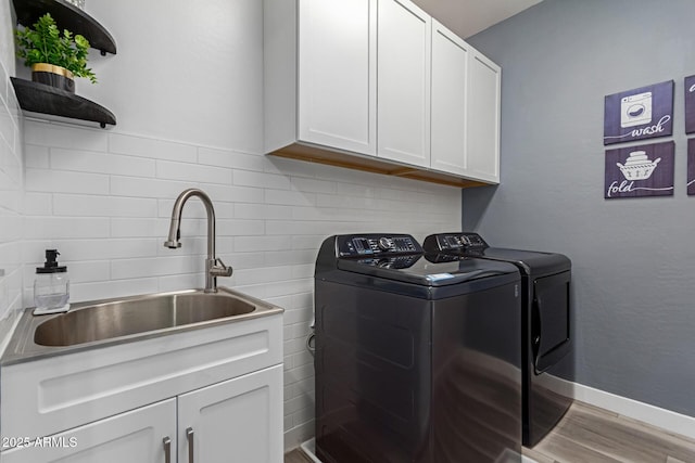 1501 E Rakestraw Ln, Gilbert, AZ 85298 - laundry room with washing machine and dryer, cabinet space, and wood finished floors