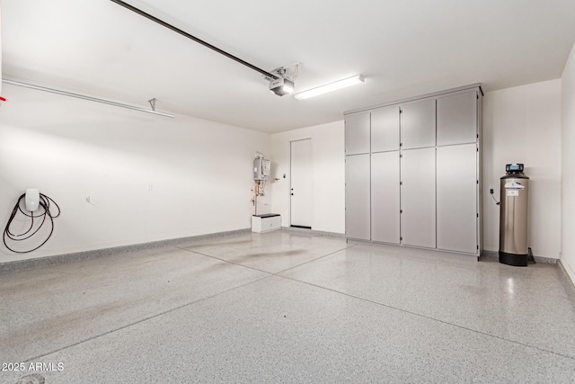 1501 E Rakestraw Ln, Gilbert, AZ 85298 - garage featuring a garage door opener, water heater, and baseboards