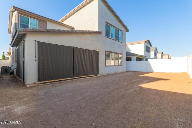 1501 E Rakestraw Ln, Gilbert, AZ 85298 - back of house featuring stucco siding and cooling unit