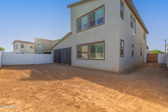 1501 E Rakestraw Ln, Gilbert, AZ 85298 - back of house featuring a fenced backyard, a gate, and stucco siding