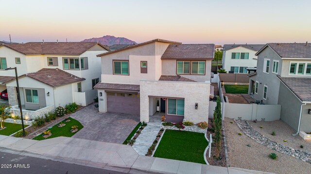 1501 E Rakestraw Ln, Gilbert, AZ 85298 - view of front of property featuring stucco siding, decorative driveway, a residential view, an attached garage, and stone siding
