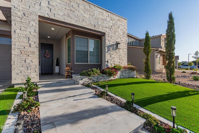 1501 E Rakestraw Ln, Gilbert, AZ 85298 - view of exterior entry featuring stone siding and a lawn