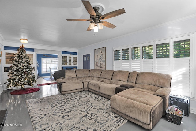 living room with ceiling fan, ornamental molding, and a wealth of natural light