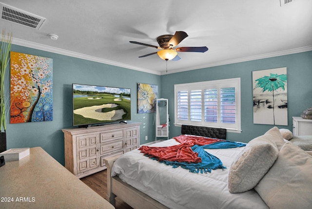 bedroom featuring ceiling fan, dark hardwood / wood-style floors, and crown molding