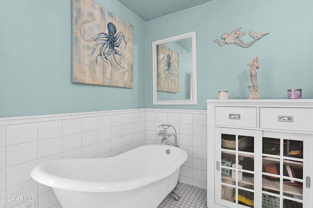 bathroom featuring tile patterned flooring, tile walls, and a bathing tub