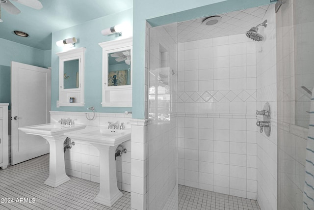 bathroom featuring a tile shower, tile patterned floors, ceiling fan, and tile walls