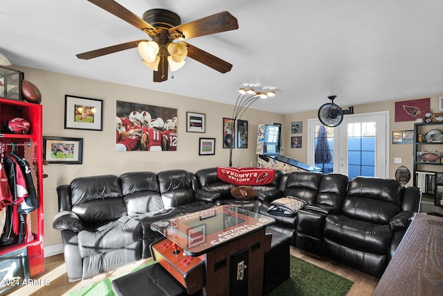 living room with hardwood / wood-style flooring, ceiling fan, and french doors