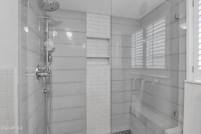 bathroom with a tile shower