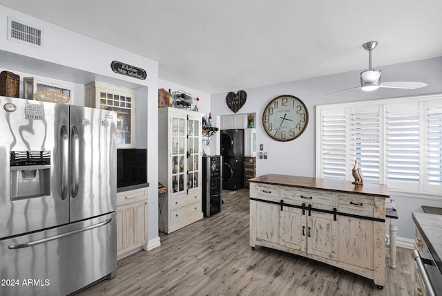 kitchen featuring ceiling fan, stainless steel fridge, light hardwood / wood-style floors, and decorative light fixtures