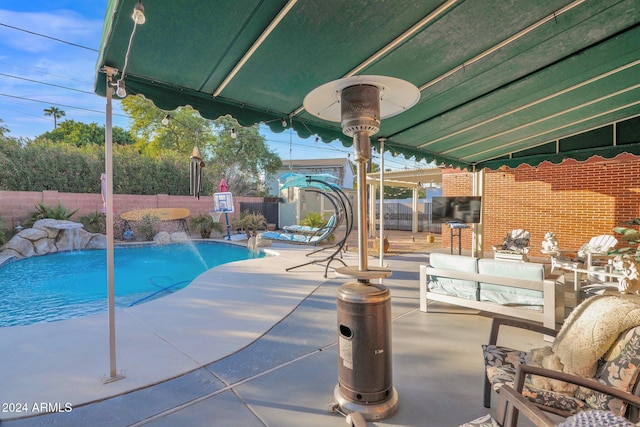 view of pool with pool water feature, area for grilling, a patio area, and outdoor lounge area