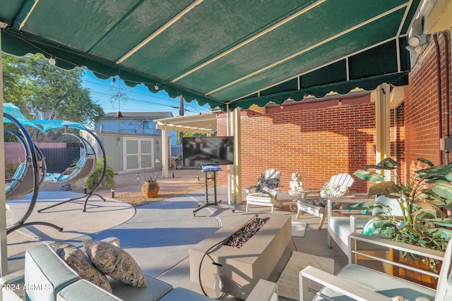 view of patio / terrace featuring a storage unit and an outdoor living space with a fire pit