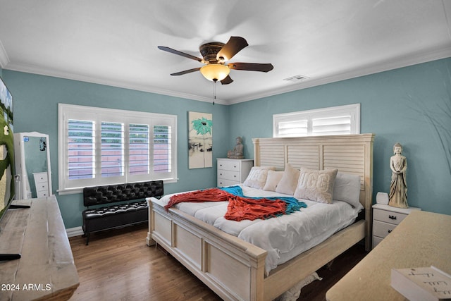 bedroom featuring dark hardwood / wood-style floors, multiple windows, ornamental molding, and ceiling fan