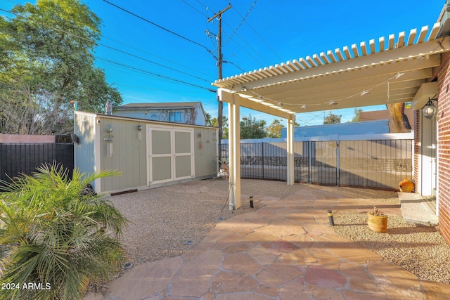 view of patio featuring a pergola and a storage shed