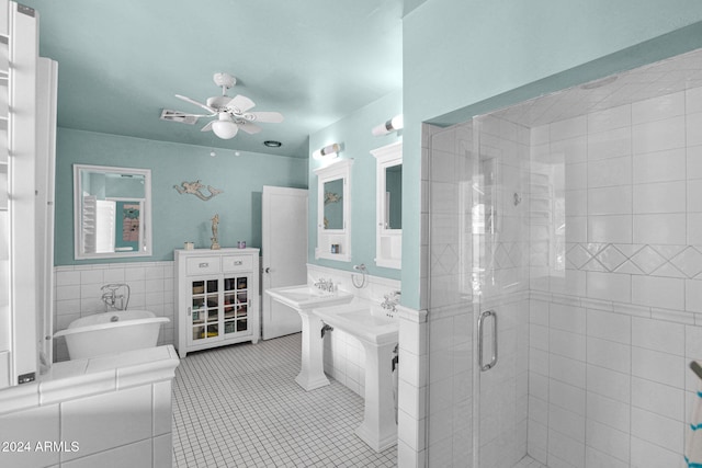 bathroom featuring tile patterned floors, ceiling fan, sink, tile walls, and independent shower and bath