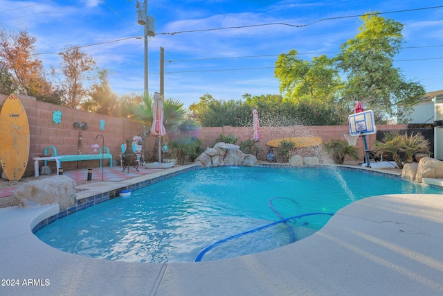 view of pool featuring pool water feature and a patio