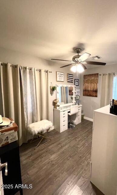 office area featuring baseboards, visible vents, ceiling fan, and dark wood finished floors