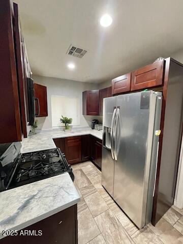 kitchen featuring visible vents, recessed lighting, reddish brown cabinets, light countertops, and appliances with stainless steel finishes