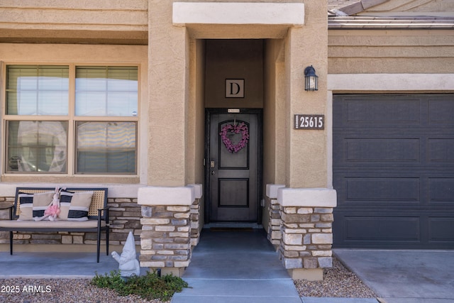 doorway to property featuring stone siding, a porch, and stucco siding