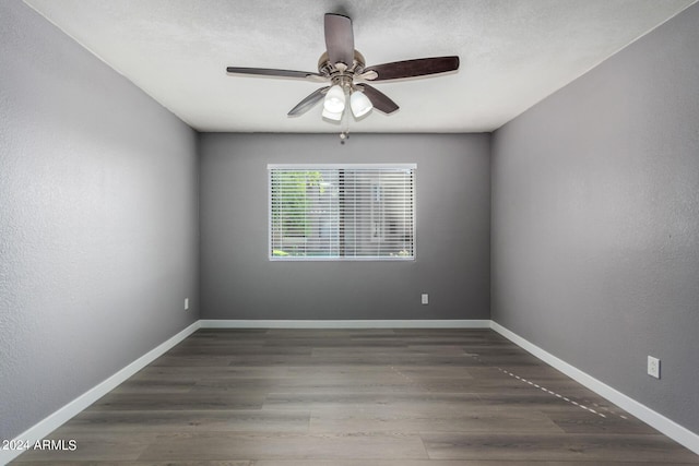 spare room with wood finished floors and baseboards