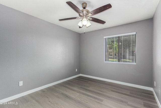 unfurnished room with ceiling fan, baseboards, and wood finished floors