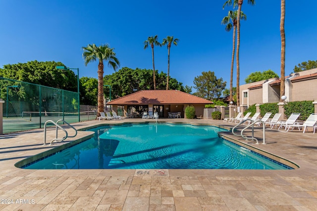 community pool featuring a patio and fence