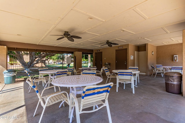 view of patio featuring a ceiling fan, outdoor dining space, and fence