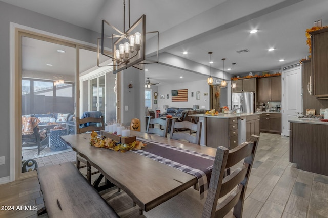 dining room with ceiling fan with notable chandelier