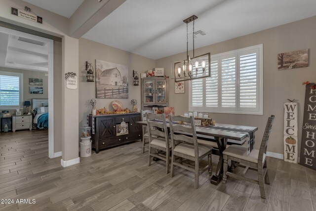 dining room featuring wood-type flooring and a chandelier