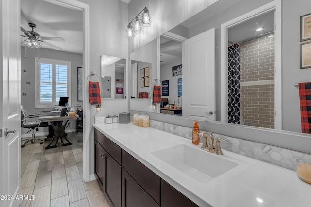 bathroom with walk in shower, vanity, and ceiling fan