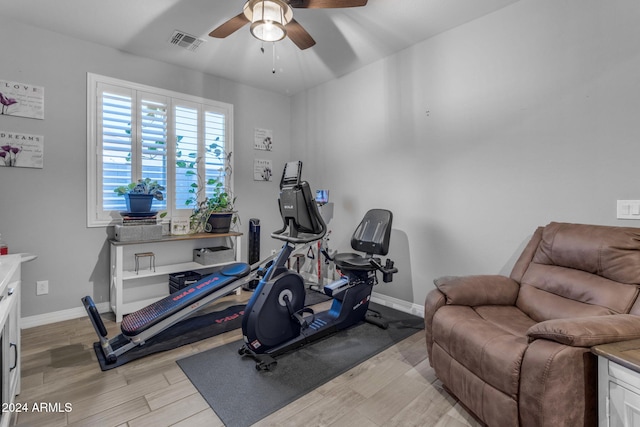 exercise area with light wood-type flooring and ceiling fan