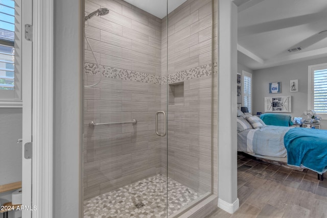 bathroom featuring hardwood / wood-style floors and a shower with door