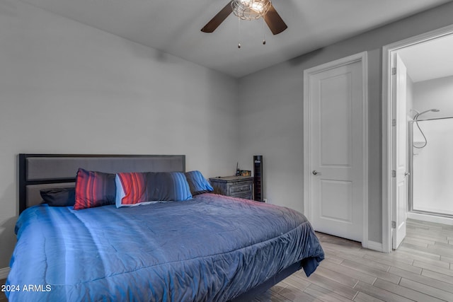 bedroom with ceiling fan, connected bathroom, and light wood-type flooring