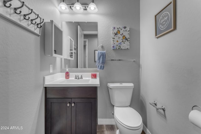 bathroom featuring hardwood / wood-style floors, vanity, and toilet