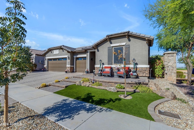 view of front of property with a garage and a front yard