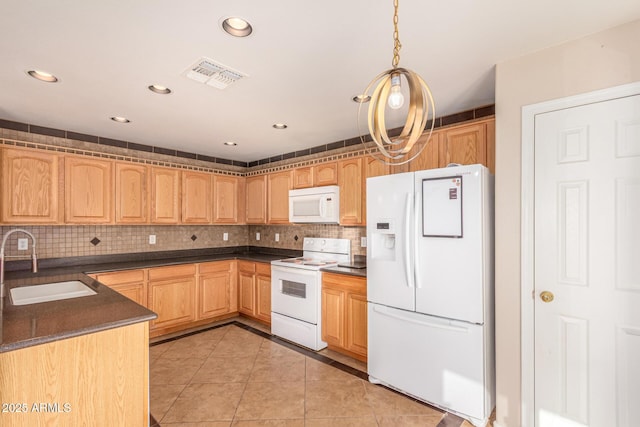 kitchen featuring white appliances, light tile patterned floors, visible vents, a sink, and dark countertops