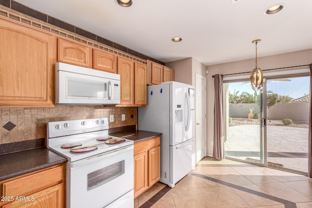 kitchen featuring decorative backsplash, white appliances, recessed lighting, and dark countertops