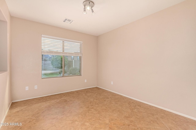 spare room with visible vents and baseboards