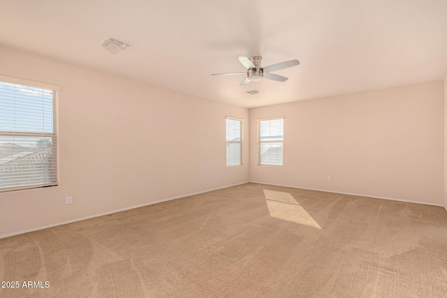 unfurnished room featuring light carpet and visible vents