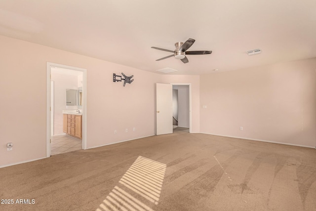 unfurnished room with light colored carpet, visible vents, and ceiling fan