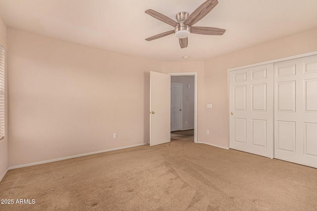 unfurnished bedroom featuring ceiling fan, baseboards, a closet, and light carpet