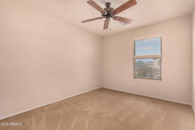 spare room with visible vents, light carpet, baseboards, and a ceiling fan