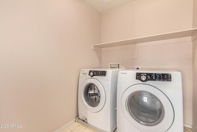 laundry room with laundry area, washing machine and dryer, baseboards, and light floors