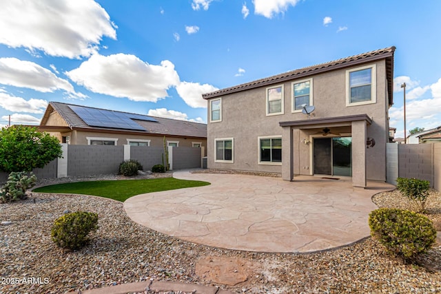 rear view of house featuring a patio area, stucco siding, and a fenced backyard