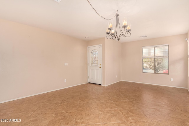 empty room featuring light tile patterned floors, visible vents, baseboards, and a notable chandelier