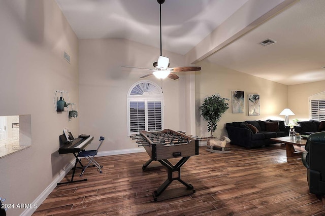 playroom featuring ceiling fan, dark hardwood / wood-style floors, and vaulted ceiling with beams