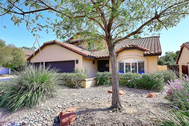 mediterranean / spanish-style home with a garage