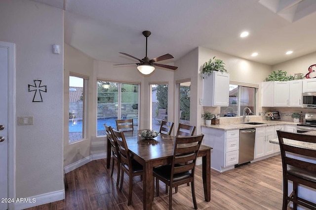 dining area featuring sink, ceiling fan, and light hardwood / wood-style flooring