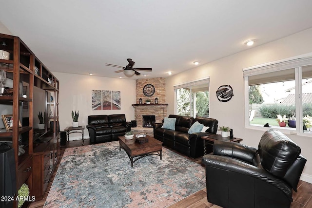 living room featuring a fireplace, hardwood / wood-style flooring, and ceiling fan