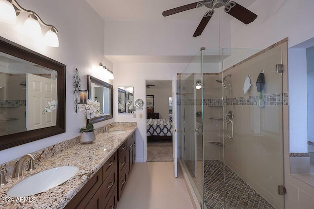 bathroom with walk in shower, vanity, tile patterned flooring, and ceiling fan