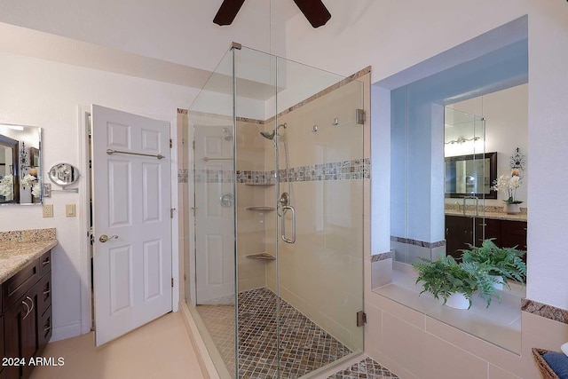 bathroom featuring ceiling fan, walk in shower, tile patterned flooring, and vanity